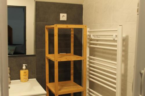 a bathroom with a wooden shelf next to a sink at Royal Racing Suite Top 5 near Red Bull Ring in Judenburg
