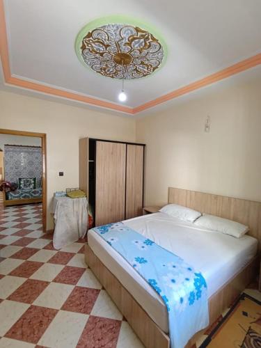 a bedroom with a large bed and a ceiling at Set in Taza