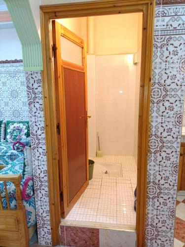 a bathroom with a door open to a bathroom with a shower at Set in Taza