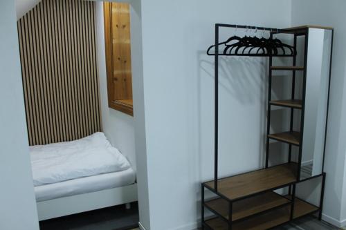 a room with a bed and a shelf and a mirror at Royal Racing Suite Top 6 near Red Bull Ring in Judenburg