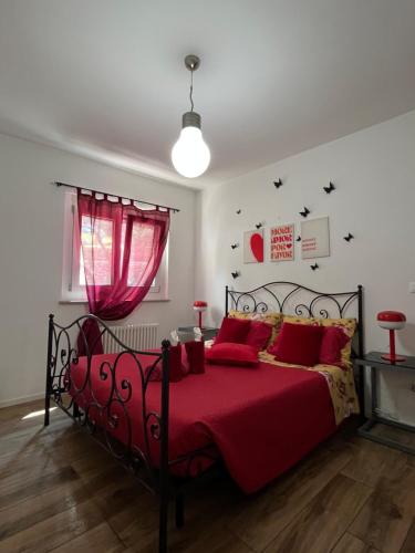 a bedroom with a red bed with a red blanket at Lake Apartment Ischia Red, Lago di Caldonazzo in Tenna 