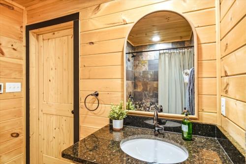 a bathroom with a sink and a mirror at Heavenly Daze Amazing Mountain View, Hot Tub, Game Room! in Sevierville