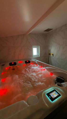 a bath tub with red lights in a bathroom at Sauna spa in Rouen