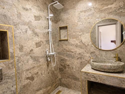 a bathroom with a sink and a mirror at Apartmani Enydoo in Ulcinj