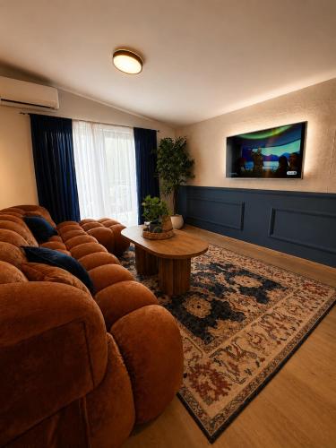 a living room with a couch and a table at Monti Wellness & Spa Vlašić in Vlasic