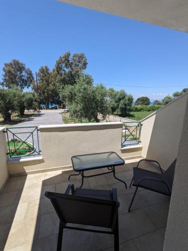 a balcony with two chairs and a table at Harmony Sunset in Skala Sotiros