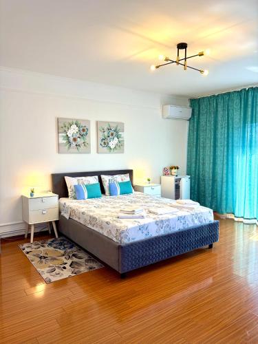 a bedroom with a bed and a blue curtain at Casa Cristian Techirghiol in Techirghiol