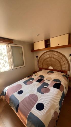 a bedroom with a large bed with a large bedspread at Les 3oliviers in Santa-Maria-Siché