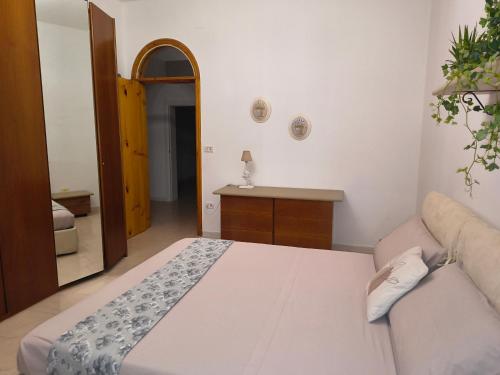 a bedroom with a bed and a couch in it at casa vacanza in Laterza