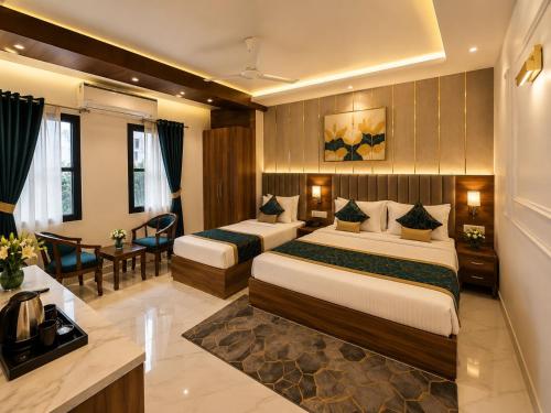 a hotel room with two beds and a desk at Hotel Montanaa Plaza Near Delhi Airport - Free Airport Pickup & Drop and Breakfast- Dinner complementary in New Delhi