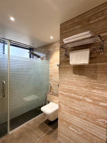 a bathroom with a toilet and a glass shower at Nova Bliss Villa in Nashik