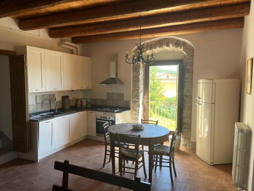 a kitchen with a table and chairs and a kitchen with a table and a kitchen at Il Convento di Laura in Civitanova del Sannio
