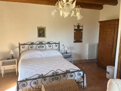 a bedroom with a bed and a chandelier at Il Convento di Laura in Civitanova del Sannio