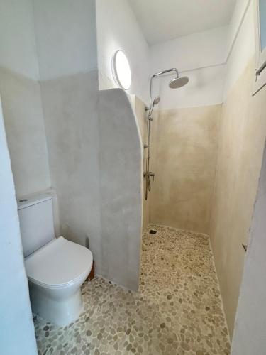 a bathroom with a toilet and a shower at 7Olives Emerald Boutique Apartment in Kastraki