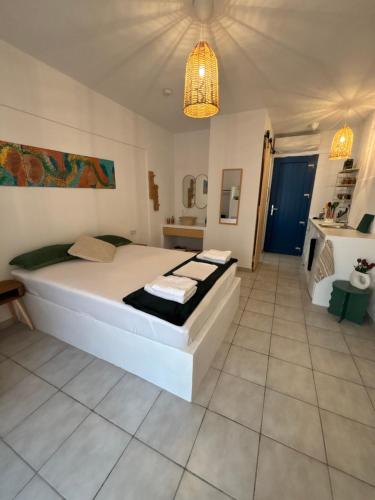 a bedroom with a large bed and a bathroom at 7Olives Emerald Boutique Apartment in Kastraki