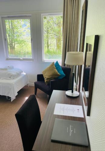 a living room with a table with a sign on it at Lindum Hotell in Suldalsosen