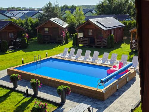a swimming pool with a slide in a yard at Arcada in Jarosławiec
