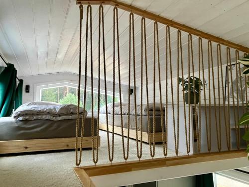 a bedroom with a bed in a swing at Fuchs und Igel Tiny House - Tiny House Fuchs in Möllensee