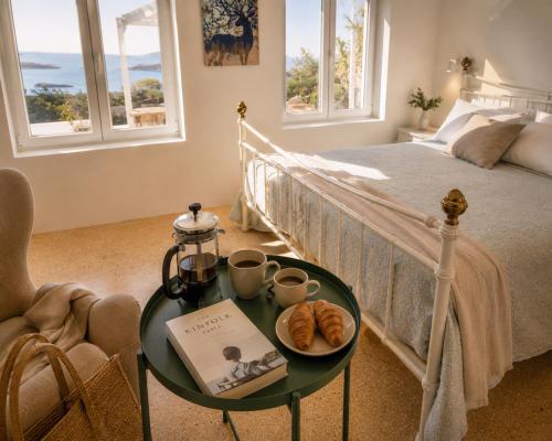 a bedroom with a bed and a table with croissants on it at Ni&Gio Sterna 1 in Parikia