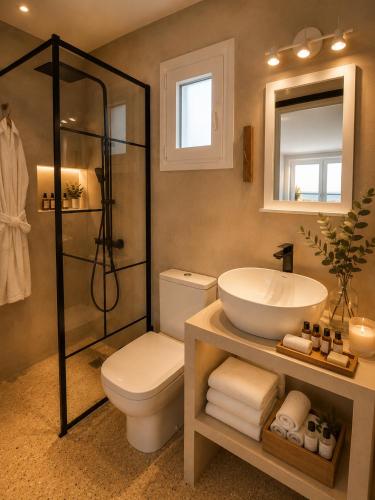 a bathroom with a toilet and a sink and a shower at Ni&Gio Sterna 1 in Parikia