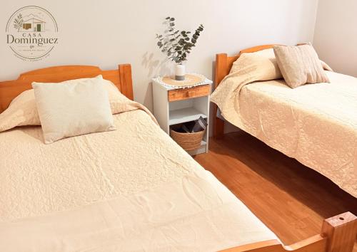 a bedroom with two beds and a night stand at Taltal - Casa Dominguez in Taltal