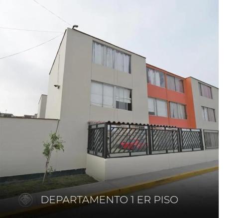 a white building with a balcony in front of it at Torre in Carabayllo