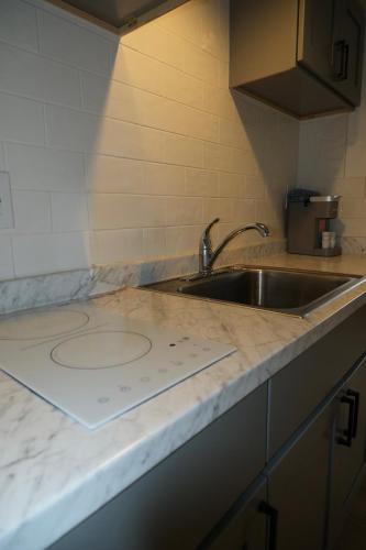 a kitchen with a sink and a counter top at Cape Harbor Motor Inn in Cape May