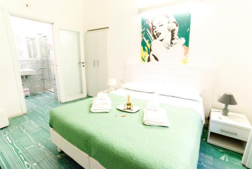 a bedroom with a bed and a bathroom with a sink at Divine Bed & Breakfast in Rome