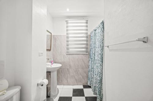 a bathroom with a sink and a shower curtain at LISBD7D - JL Condado in San Juan
