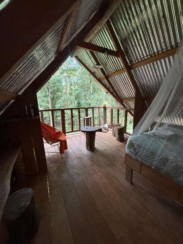 a room with a bed and a table in a tent at Entire Jungle Chalet Playa Ganadito in Drake