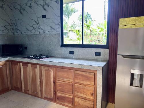 a kitchen with a counter top and a window at Yalala Jacuzzi in Jabillos