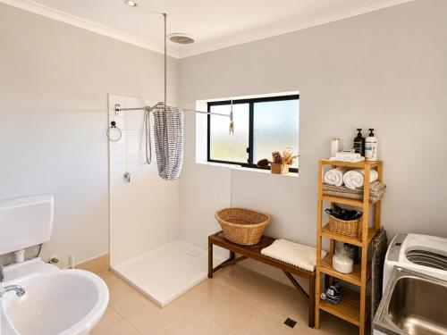 a bathroom with a sink and a toilet and a shower at Explorers Roost in Kalbarri