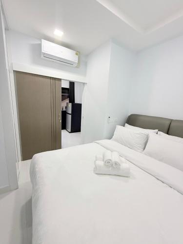 a white bed with two towels on top of it at Hana residence Bangtao BeachBangtao 11 Phuket in Ban Thalat Choeng Thale