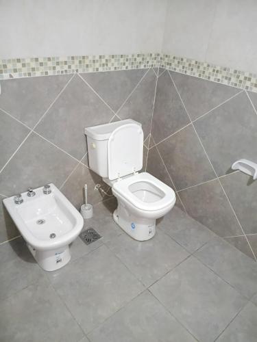 a bathroom with a toilet and a bidet at Aurum patagonia hotel in Lago Puelo