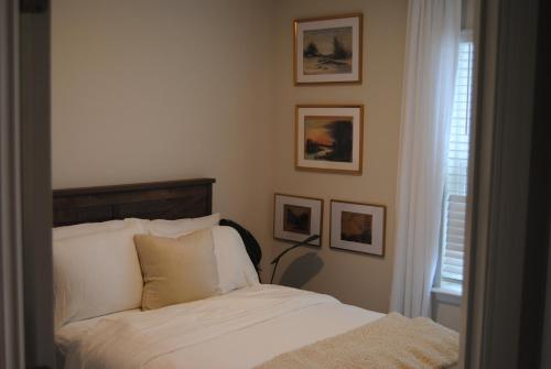 a bedroom with a bed and pictures on the wall at Milford House in Milford