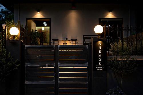a gate with a sign in front of a restaurant at Anemos Suites Loutraki in Loutraki
