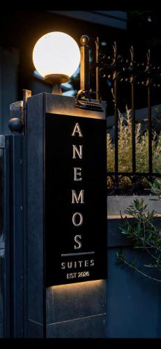 a sign for a new york suites sitting next to a lamp at Anemos Suites Loutraki in Loutraki