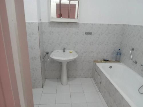 a bathroom with a sink and a bath tub and a sink at Marina tabarka in Tabarka