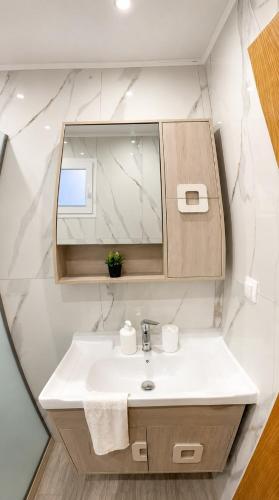 a bathroom with a sink and a mirror at Dimitra's House in Kefalos