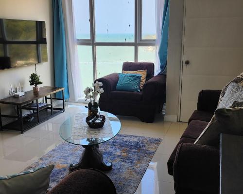 a living room with a coffee table and a view of the ocean at Beachfront Ocean View Loft with Beach, Pool and Parking in Portmore