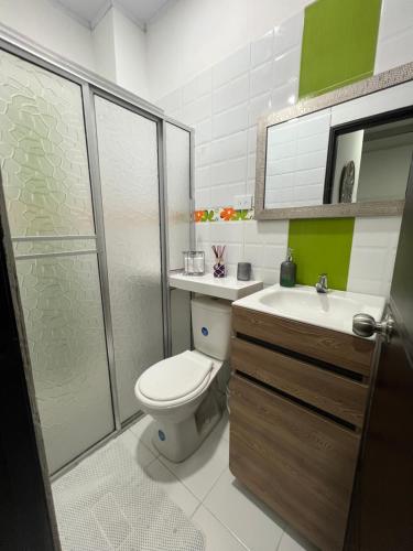 a bathroom with a toilet and a sink and a shower at Casa de Libre Independencia in Mocoa