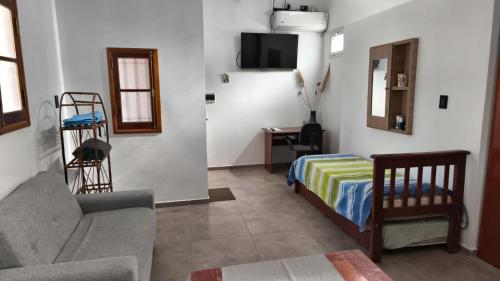 a living room with a couch and a bed at Renzo in Deán Funes