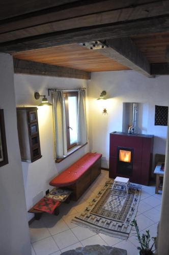a living room with a bench and a fireplace at Casa Alex in Roure Turin