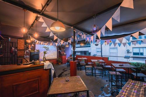 a restaurant with tables and chairs and flags hanging from the ceiling at Hostel & Spa Mediterránea in Córdoba