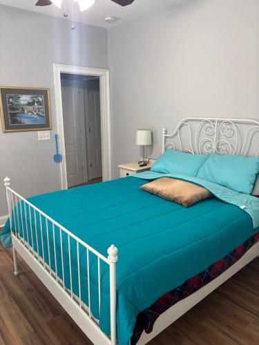 a bedroom with a bed with a blue blanket at The Abigail in Braselton