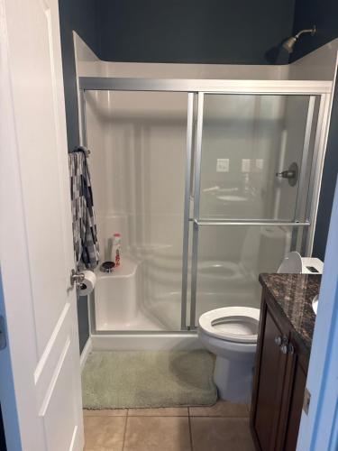 a bathroom with a shower and a toilet at The Abigail in Braselton