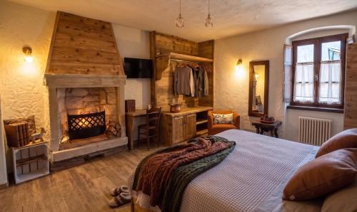 a bedroom with a large bed and a fireplace at Le Orme in Tenno