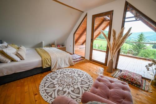 a bedroom with a bed and a large window at Country Chic Villa with Pool in Mrginj