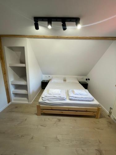 a small bedroom with a bed in an attic at Sielankowo in Rożnów