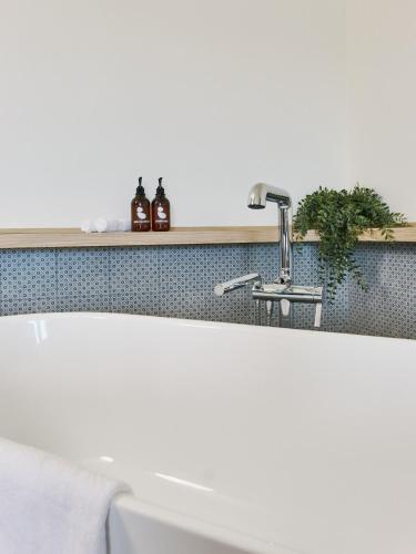 a bathroom sink with a faucet on a counter at BATTURES Hotel Fjord Saguenay in La Baie